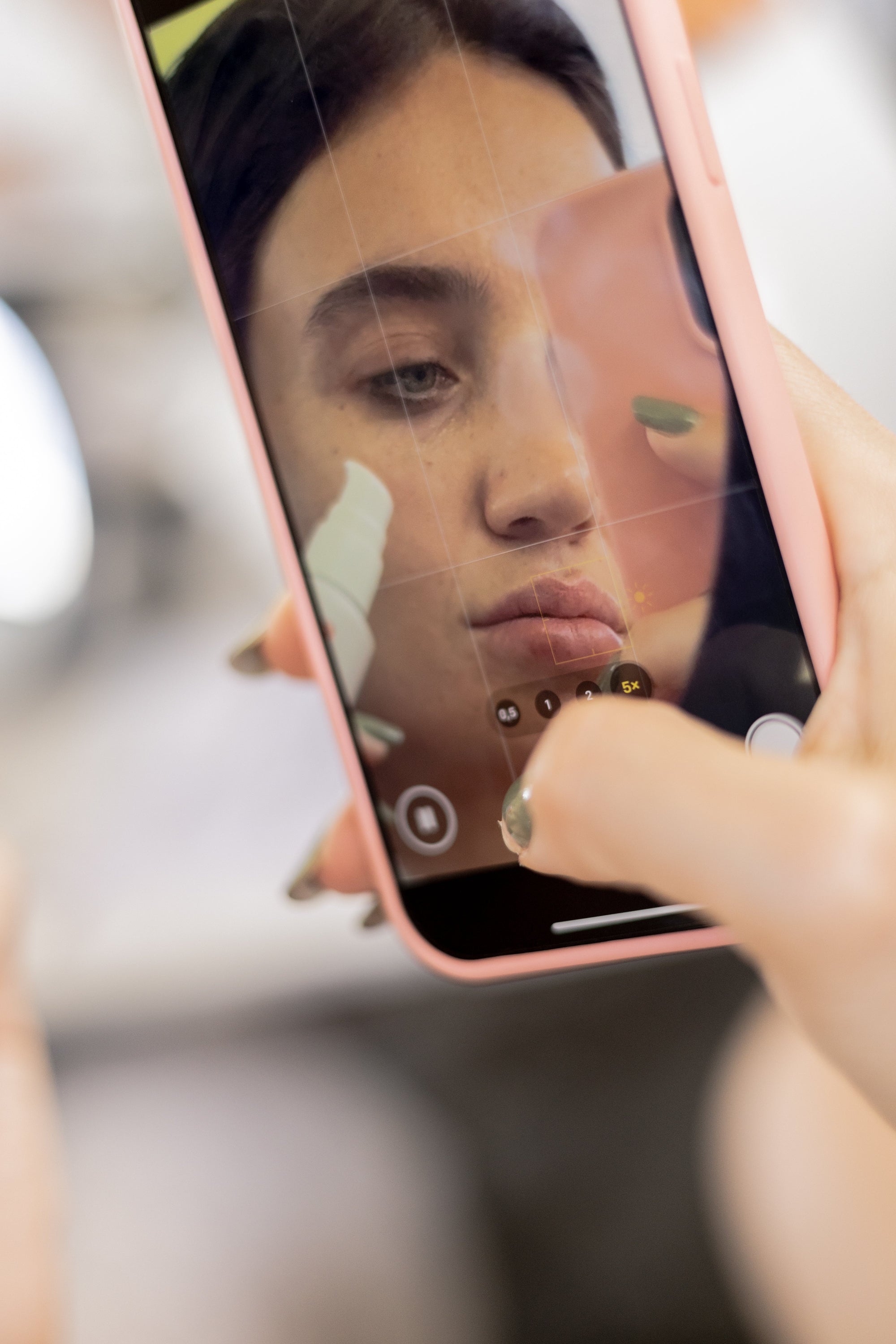 Woman applying only a few essential skincare products, illustrating the skinimalism trend and microbiome-friendly approach.