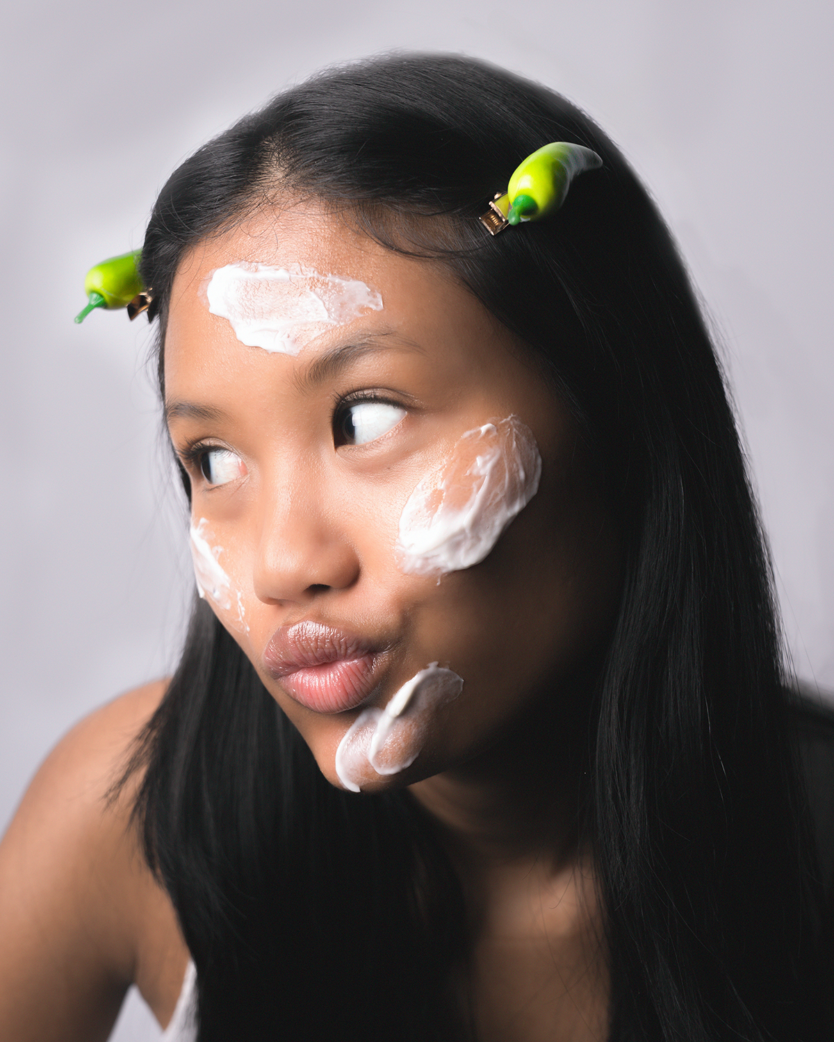 Woman with glowing skin applying a microbiome-friendly moisturizer to strengthen the skin barrier and improve skin hydration.