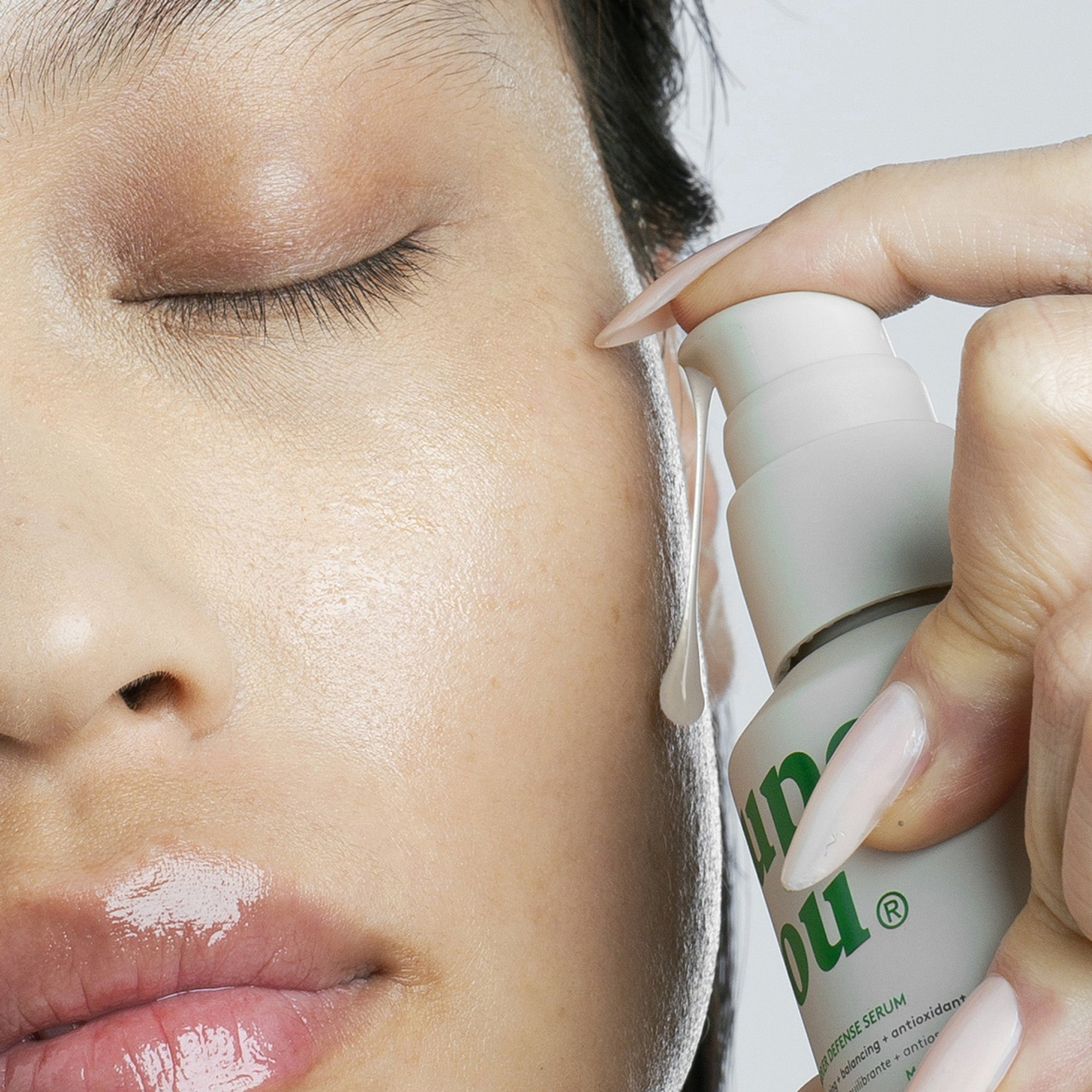 Woman applying barrier repair serum to calm red, dry, irritated skin and restore a damaged skin barrier naturally.