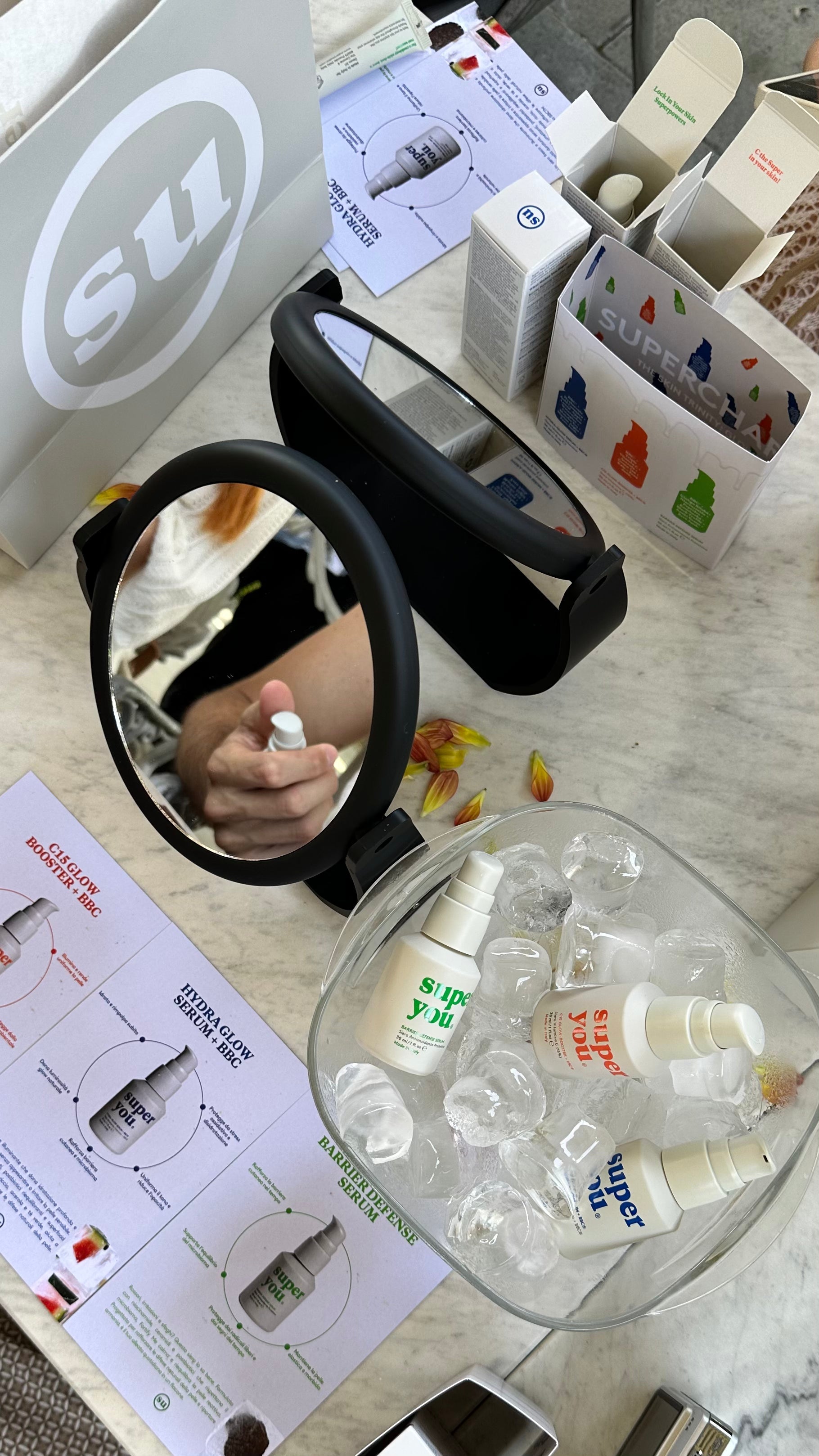 Woman applying a few essential skincare products, representing a simplified and personalized skin routine.