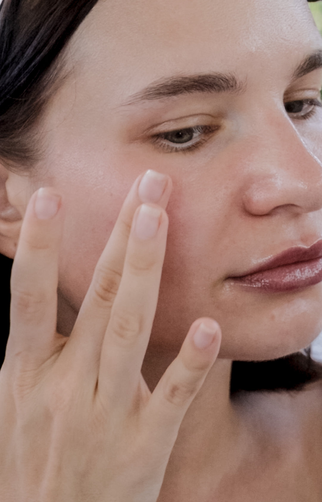 Woman with calm, healthy skin following a simple skincare routine.
