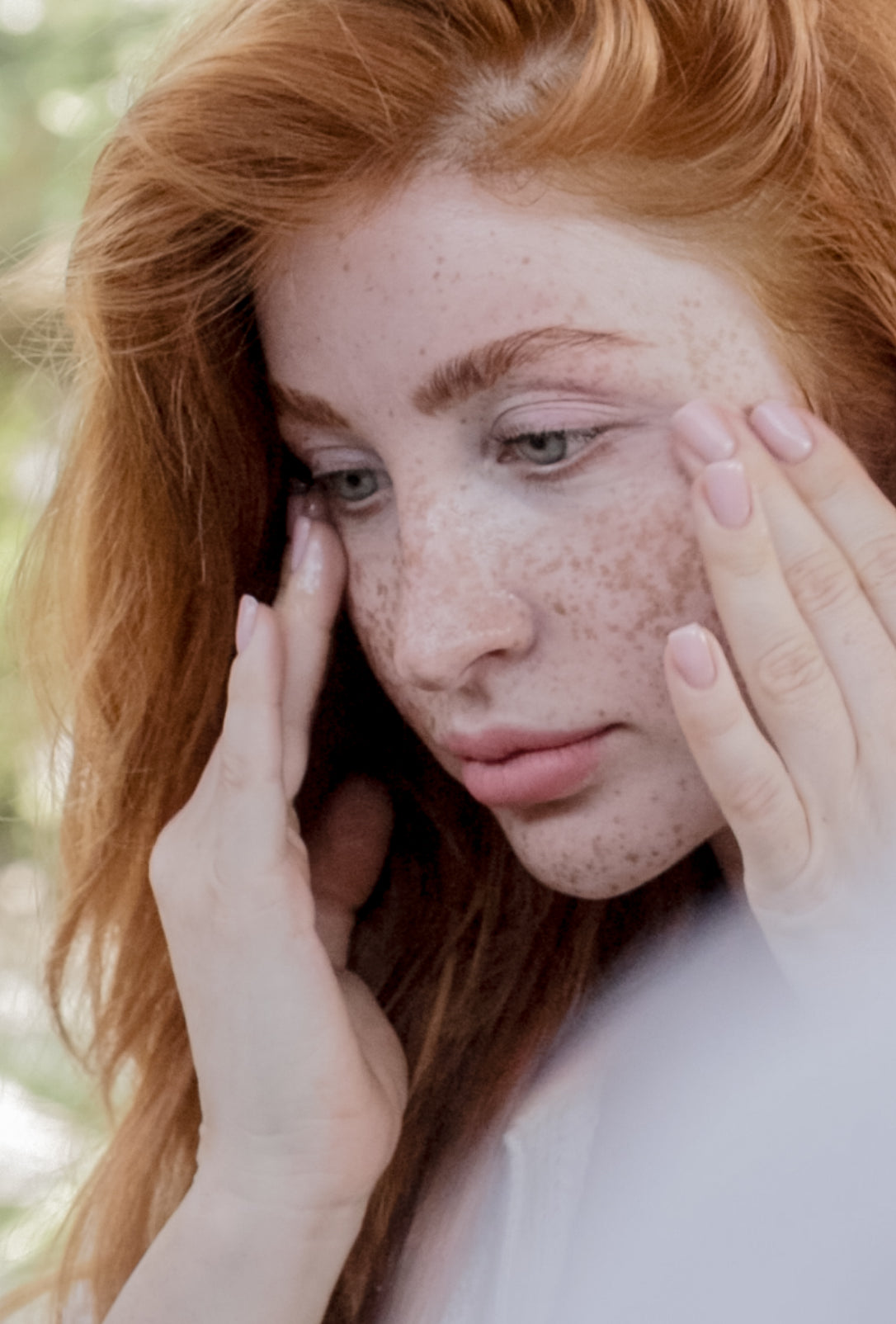 Woman with sensitive, irritated skin applying microbiome-friendly skincare to restore the skin barrier and reduce inflammation.