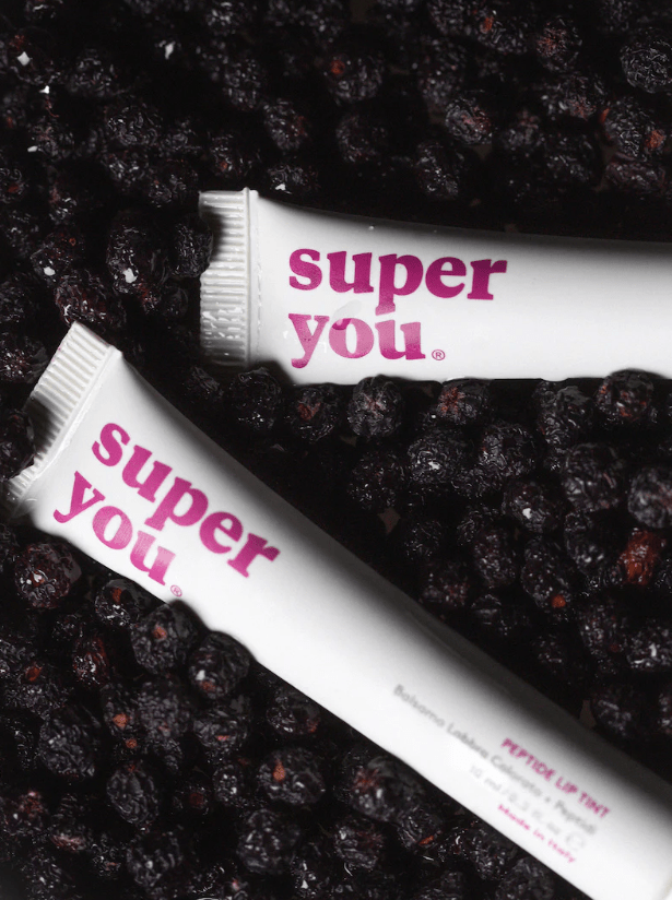 Acai berries and natural skincare products for glowing skin and lips